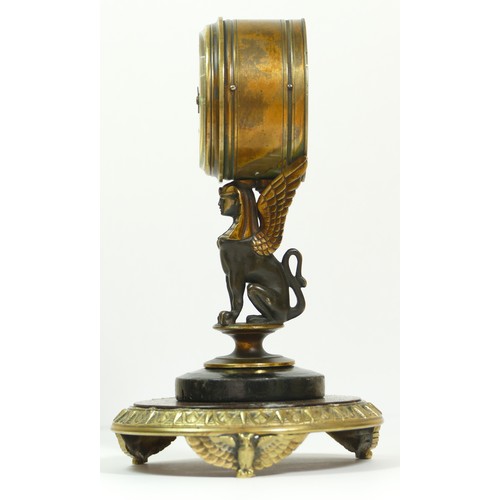 393 - A late 19th century brass aneroid barometer, raised on a bronzed patinated sphinx, to a brass stand ... 