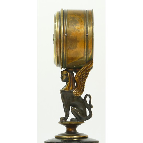 393 - A late 19th century brass aneroid barometer, raised on a bronzed patinated sphinx, to a brass stand ... 