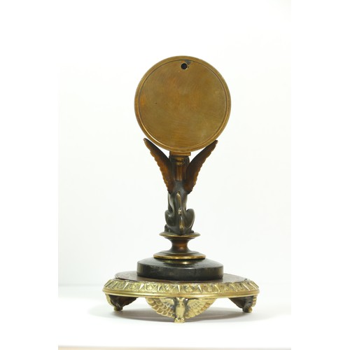 393 - A late 19th century brass aneroid barometer, raised on a bronzed patinated sphinx, to a brass stand ... 