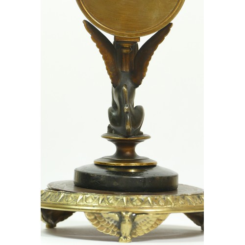 393 - A late 19th century brass aneroid barometer, raised on a bronzed patinated sphinx, to a brass stand ... 