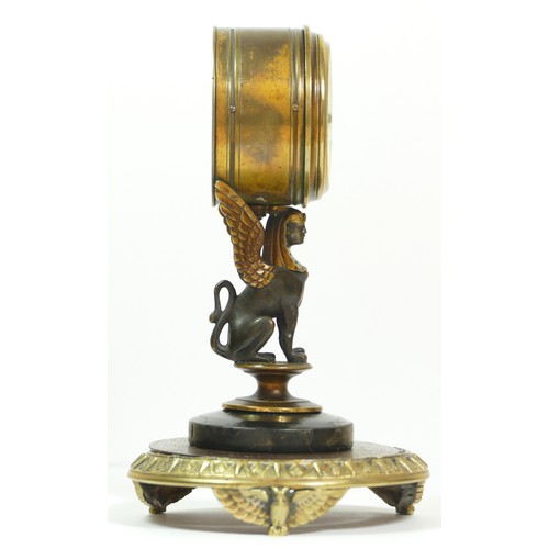 393 - A late 19th century brass aneroid barometer, raised on a bronzed patinated sphinx, to a brass stand ... 