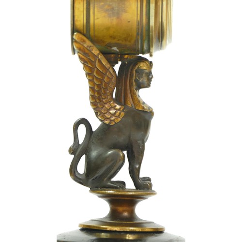 393 - A late 19th century brass aneroid barometer, raised on a bronzed patinated sphinx, to a brass stand ... 