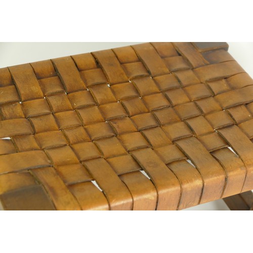 568 - A Robert 'Mouseman' Thompson footstool, having cowhide interwoven strap top, supported by carved oct... 