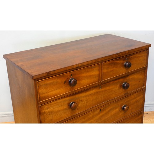 536 - An Edwardian mahogany chest of drawers, having two short over three long drawers, raised on bun feet... 