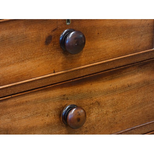 536 - An Edwardian mahogany chest of drawers, having two short over three long drawers, raised on bun feet... 