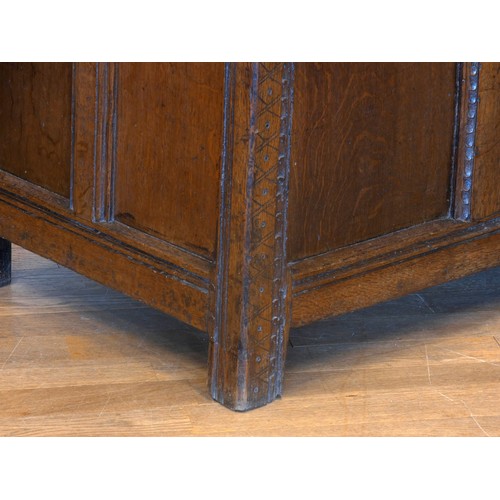 538 - A 17th century and later oak coffer, the planked hinged lid over four foliate carved recessed panels... 