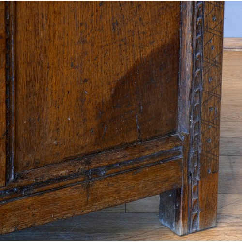 538 - A 17th century and later oak coffer, the planked hinged lid over four foliate carved recessed panels... 