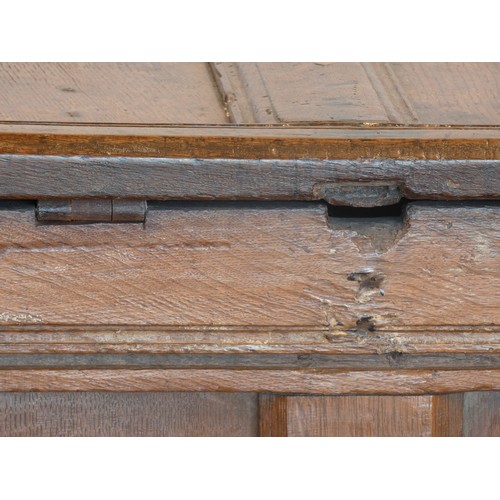 538 - A 17th century and later oak coffer, the planked hinged lid over four foliate carved recessed panels... 