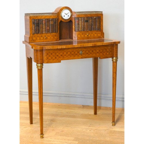 542 - A late 19th century French tulipwood and mahogany parquetry veneered writing table, central 8 day cl... 