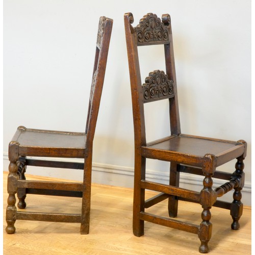 547 - A pair of 18th century oak Yorkshire chairs, the definite back crests with voluted scrolls and centr... 