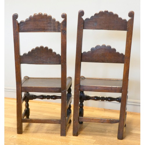 547 - A pair of 18th century oak Yorkshire chairs, the definite back crests with voluted scrolls and centr... 