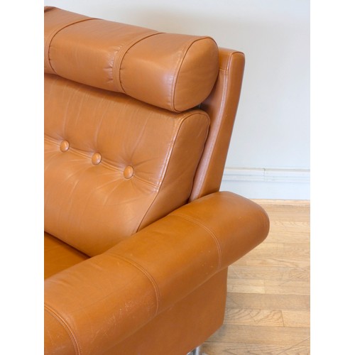 577 - A 1970s tan leather armchair, button back with spayed armrests, raised on chrome feet.
W87, H37 (sea... 