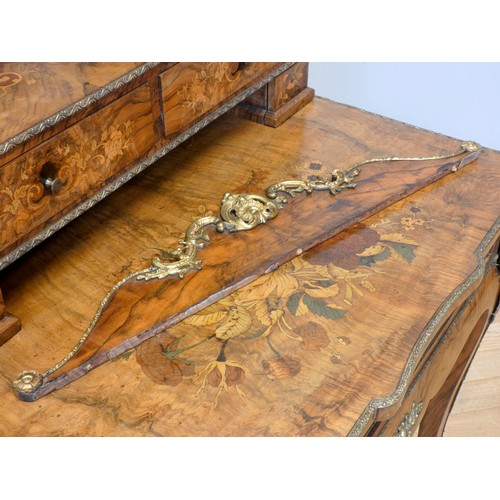 548 - A late 19th century French burr walnut and stained fruitwood writing table, with ormolu mounts, the ... 