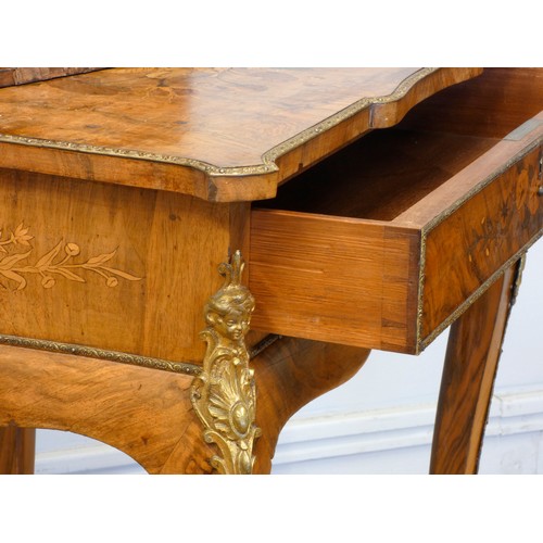 548 - A late 19th century French burr walnut and stained fruitwood writing table, with ormolu mounts, the ... 