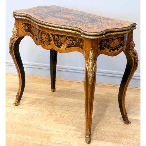 553 - A 19th century French serpentine kingwood and mahogany fold over card table, the ebony and stained f... 