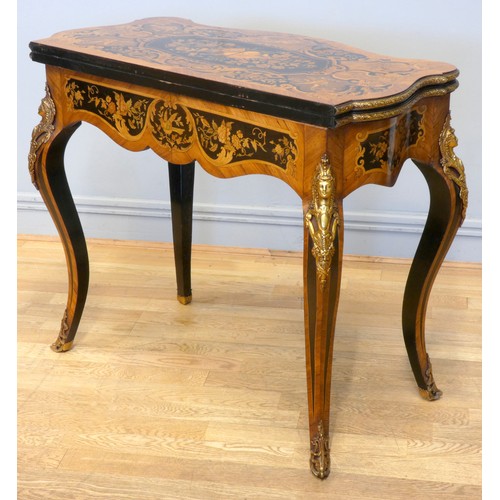 553 - A 19th century French serpentine kingwood and mahogany fold over card table, the ebony and stained f... 