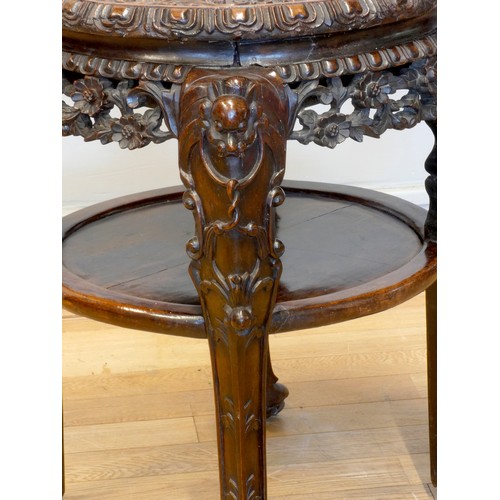 555 - A 19th century Chinese hardwood and marble circular occasional table, with pierced floral frieze, 46... 