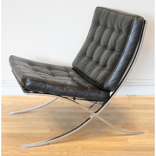 574 - A Robert Haussmann inspired Barcelona lounge chair and ottoman, upholstered black leather with butto... 