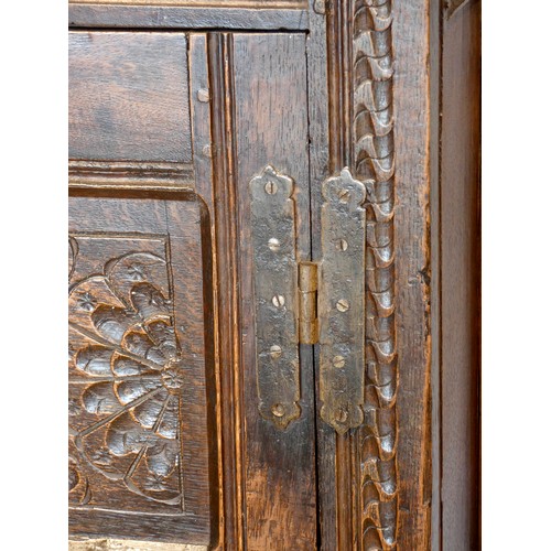 563 - Charles II and later oak press or court cupboard, dated 1688, the canopy top with inverted finials a... 