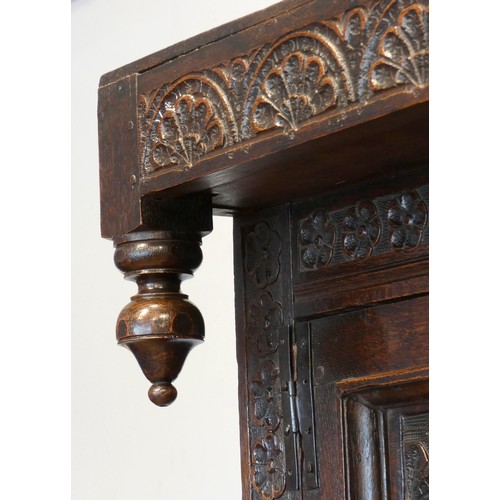 563 - Charles II and later oak press or court cupboard, dated 1688, the canopy top with inverted finials a... 