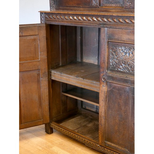 563 - Charles II and later oak press or court cupboard, dated 1688, the canopy top with inverted finials a... 