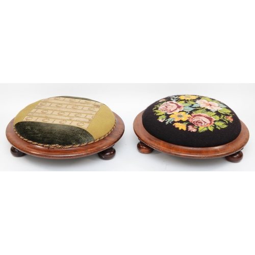 565 - A pair of Victorian embroidered footstools raised on bun feet. 37cm diameter. (2)