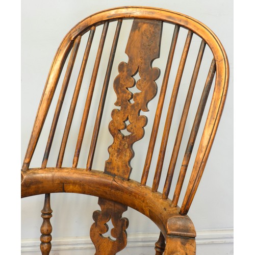 564 - A 19th century elm and yew wood hoop back Windsor chair, the stick back centred with a pierced splat... 