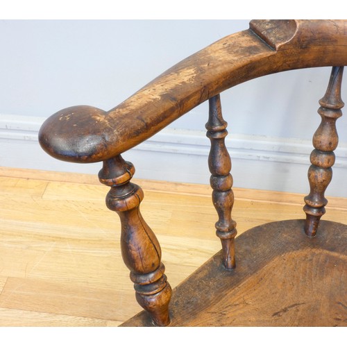 564 - A 19th century elm and yew wood hoop back Windsor chair, the stick back centred with a pierced splat... 