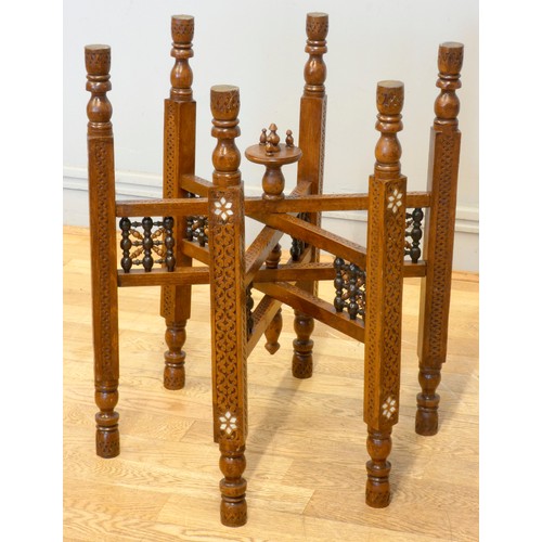 560 - An Indian brass top benares style table on folding hardwood base with mashrabiya panels and mother o... 