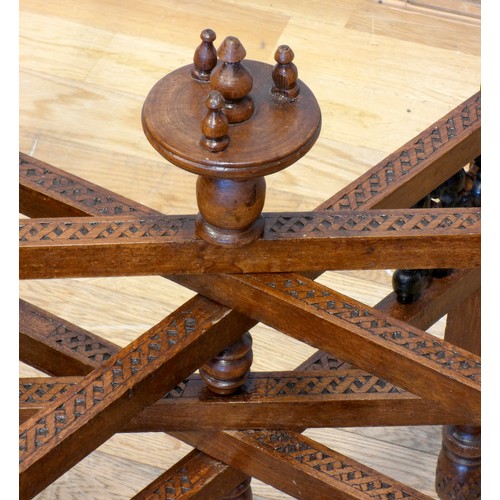 560 - An Indian brass top benares style table on folding hardwood base with mashrabiya panels and mother o... 