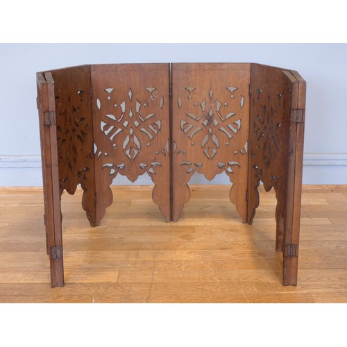 559 - An Anglo-Indian octagonal hardwood occasional table, on folding base, with intricate relief carved d... 