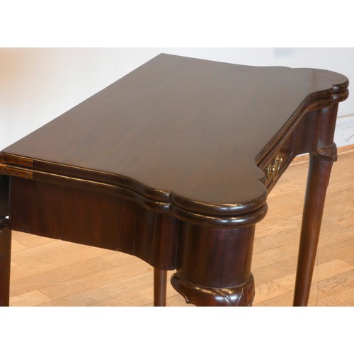 557 - A Georgian mahogany fold over side/card table, of rectangular form with projecting turret corners, c... 