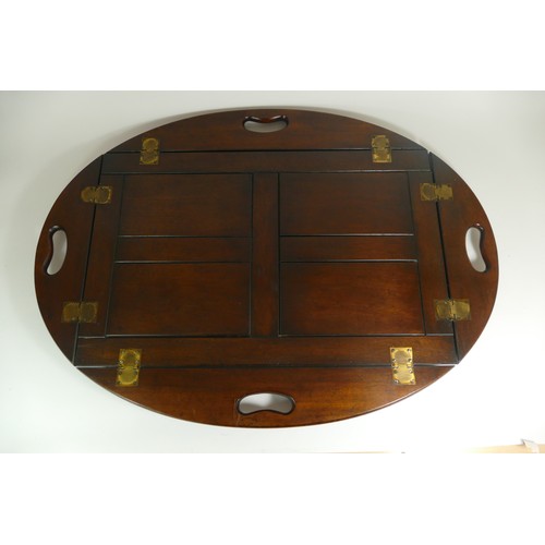 531 - A 19th century mahogany butlers tray, having panelled centre with reeded curved drop down sides. 68 ... 