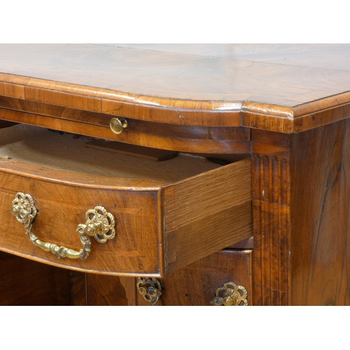 530 - A George II walnut kneehole desk, burrbanded quarter-veneered shaped top with moulded edge above bru... 