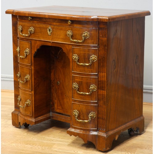 530 - A George II walnut kneehole desk, burrbanded quarter-veneered shaped top with moulded edge above bru... 