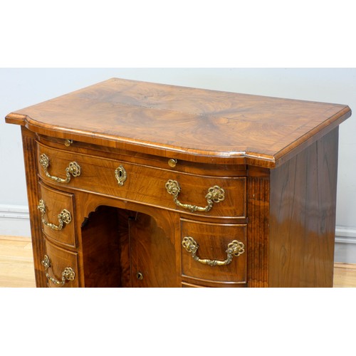 530 - A George II walnut kneehole desk, burrbanded quarter-veneered shaped top with moulded edge above bru... 