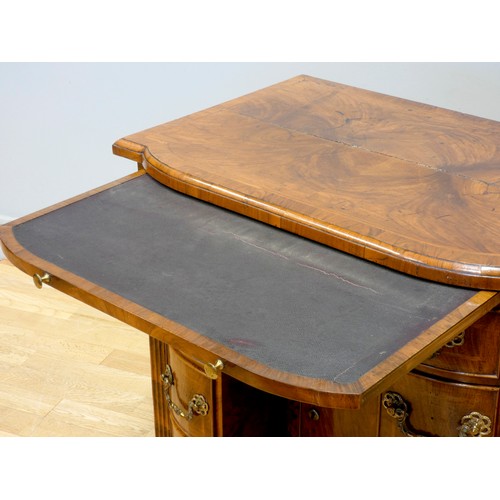 530 - A George II walnut kneehole desk, burrbanded quarter-veneered shaped top with moulded edge above bru... 