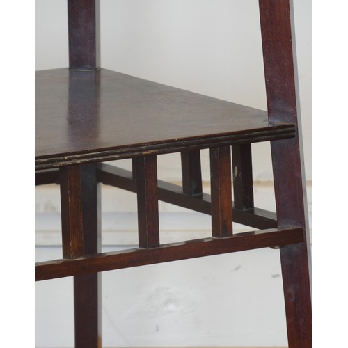 532 - A Victorian mahogany bijouterie stand, the circular top above lower galleried shelf on square brass ... 