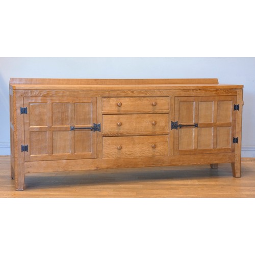 570 - A Peter 'Rabbitman' Heap of Wetwang oak panelled sideboard, with raised upstand above two cupboard d... 