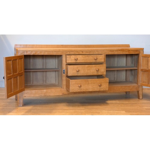 570 - A Peter 'Rabbitman' Heap of Wetwang oak panelled sideboard, with raised upstand above two cupboard d... 