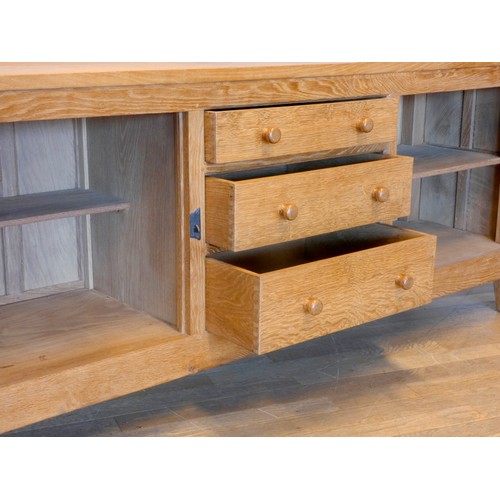 570 - A Peter 'Rabbitman' Heap of Wetwang oak panelled sideboard, with raised upstand above two cupboard d... 