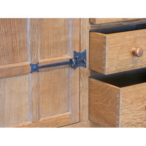 570 - A Peter 'Rabbitman' Heap of Wetwang oak panelled sideboard, with raised upstand above two cupboard d... 