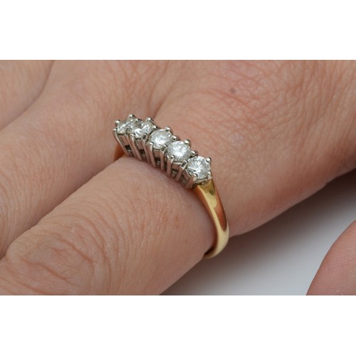 92 - An 18ct gold five stone diamond ring, claw set with brilliant cut stones, total weight approximately... 