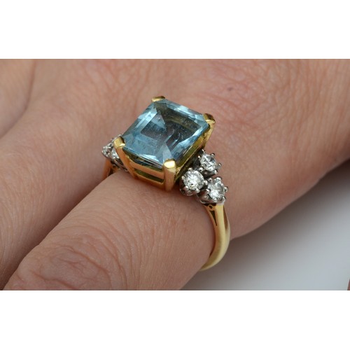 118 - An 18ct gold aquamarine and diamond dress ring, claw set with a step cut stone, 11 x 9mm, brilliant ... 