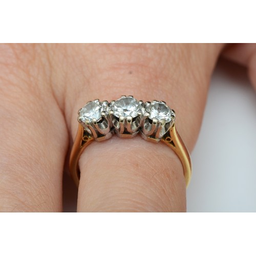 157 - An 18ct gold three stone diamond ring, London 1982, claw set with brilliant cut stones, approximatel... 