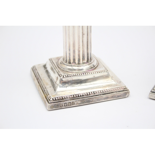 31 - A Victorian silver pair of desk candlesticks, Sheffield 1898, 12cm, loaded, lacking one scone.