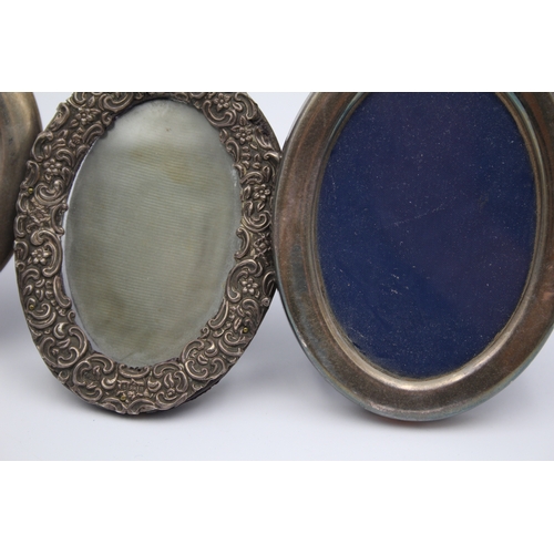 34 - An oval silver photograph frame, Sheffield 1984, 17 x 13cm and two other silver frames