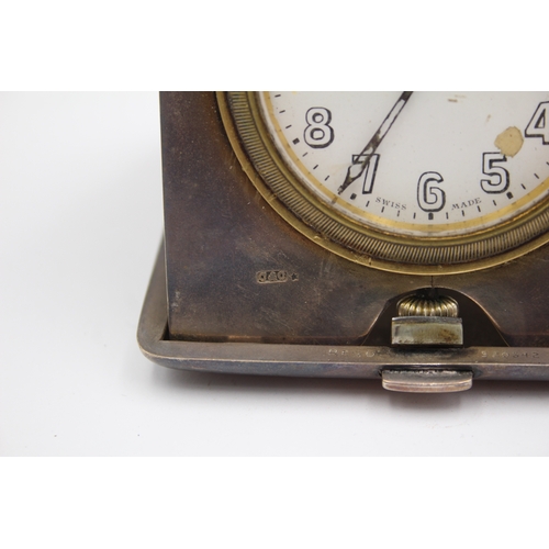 44 - A silver cased travelling 8 day bedside clock, London 1920, with engine turned decoration, 9.5 x 9.5... 