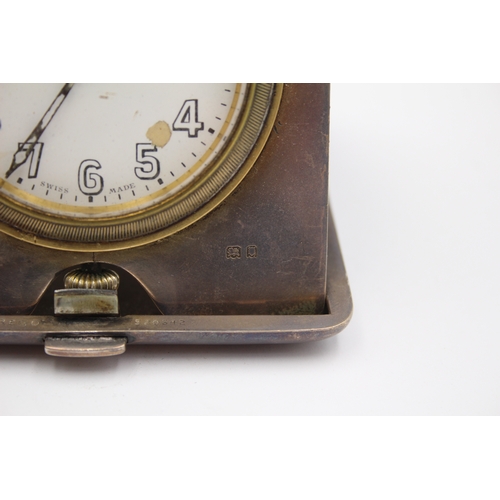 44 - A silver cased travelling 8 day bedside clock, London 1920, with engine turned decoration, 9.5 x 9.5... 