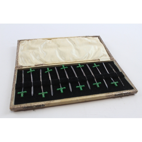 45 - A silver and green plastic set of 12 pickle swords, Birmingham 1928, lacking one handle, case